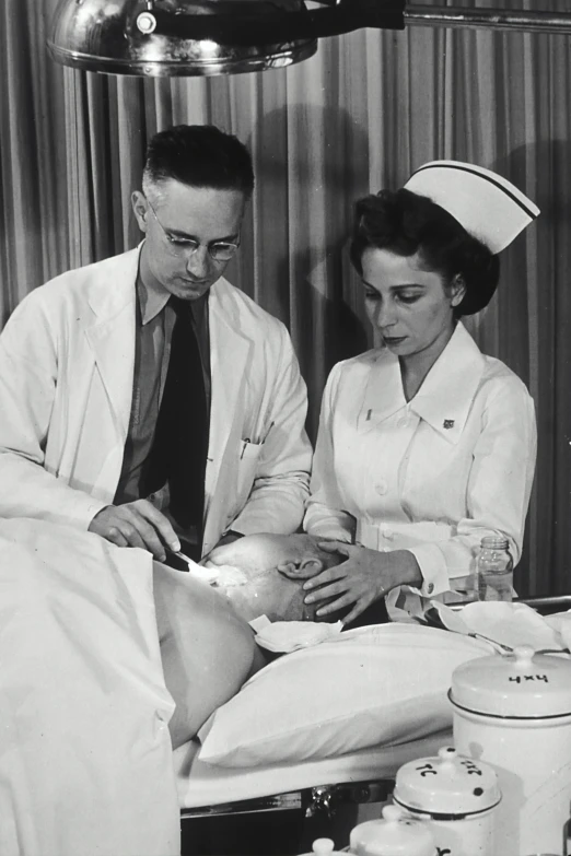 a nurse sitting next to a man who is in bed