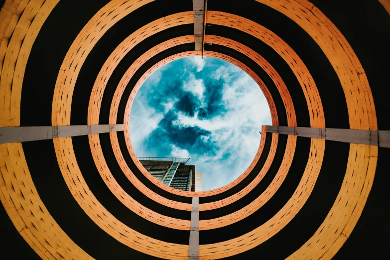 an abstract view of a circular structure with a sky in the center