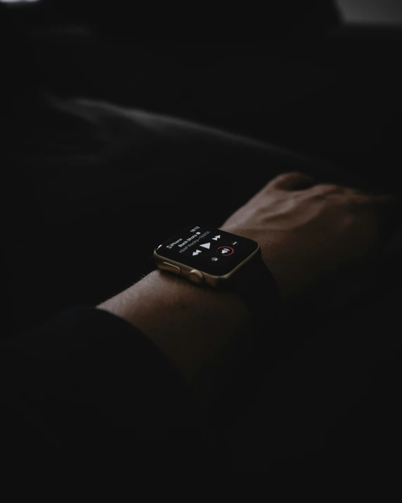 an apple watch is being worn in the dark