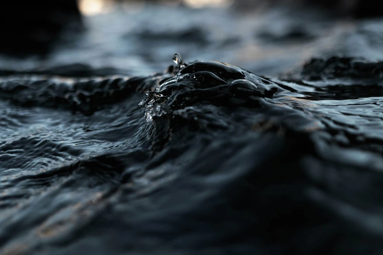 a close up of water flowing over the rocks