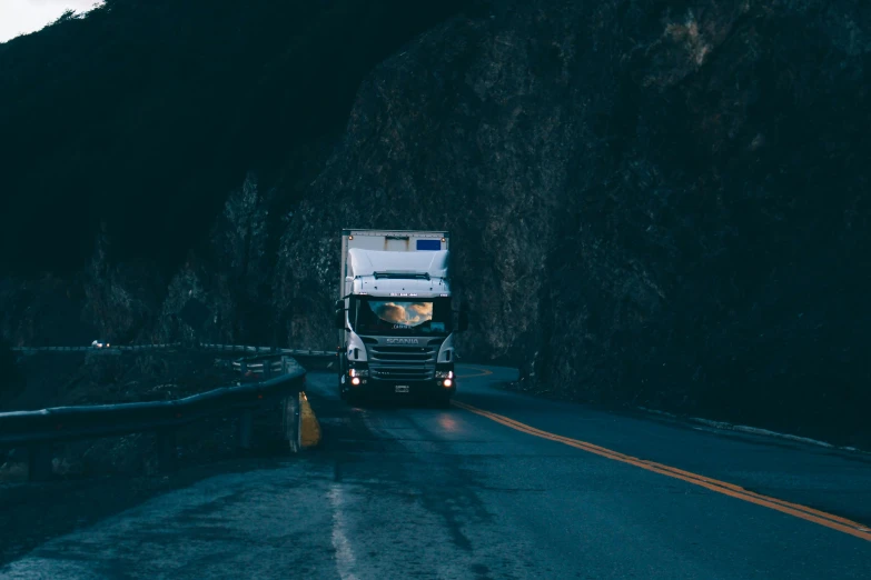 a large truck is driving on the road