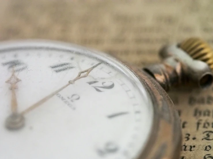 a watch laying on top of an old book