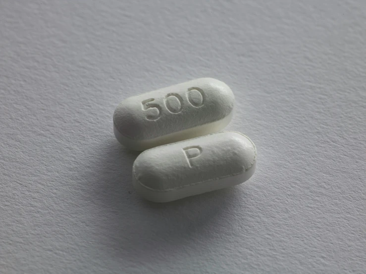 two pills with one pill shaped like the letter p