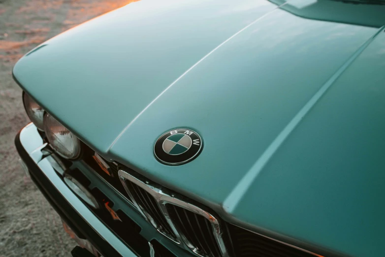 the front end of a light green car