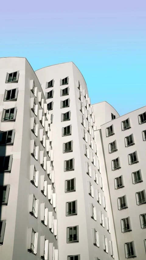 a tall white building with balconies and lots of windows