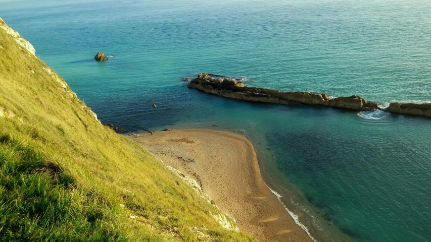 an aerial view of an old pier on a large body of water