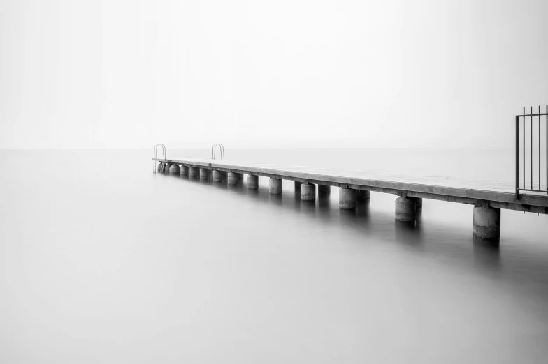 a black and white po of a pier with a guard rail