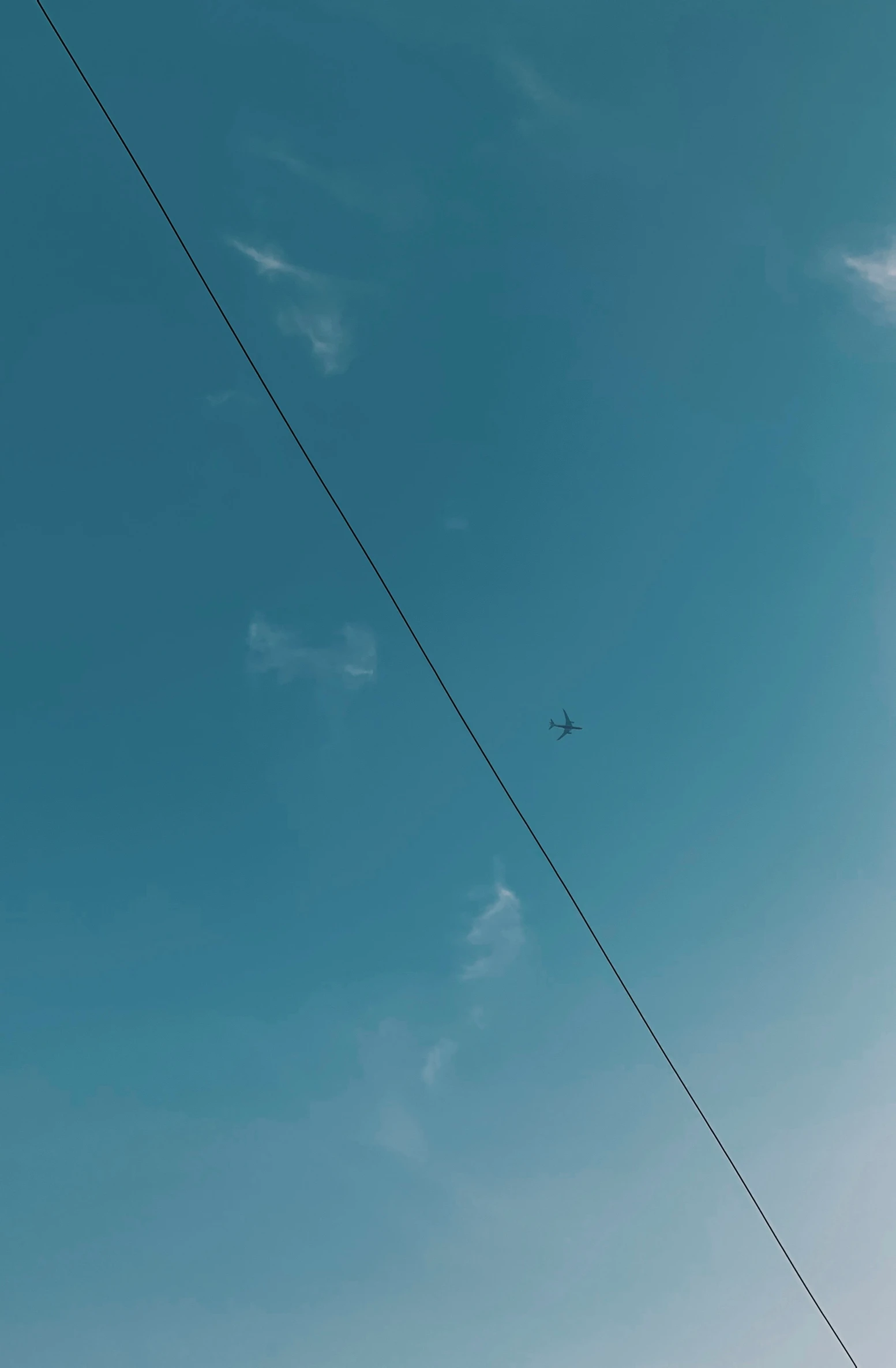 a couple of power lines and an airplane