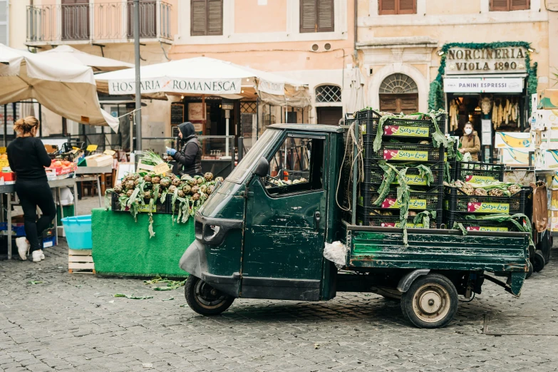 small pickup truck loaded with fruits and vegetables on display