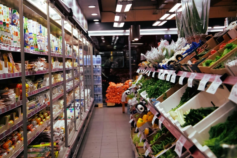 a wide aisle way lined with lots of groceries