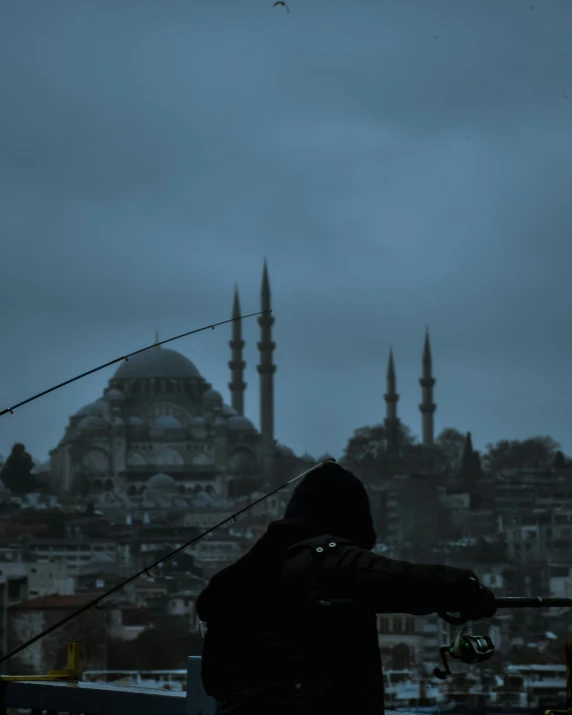 a man fishing from the rooftop of a building