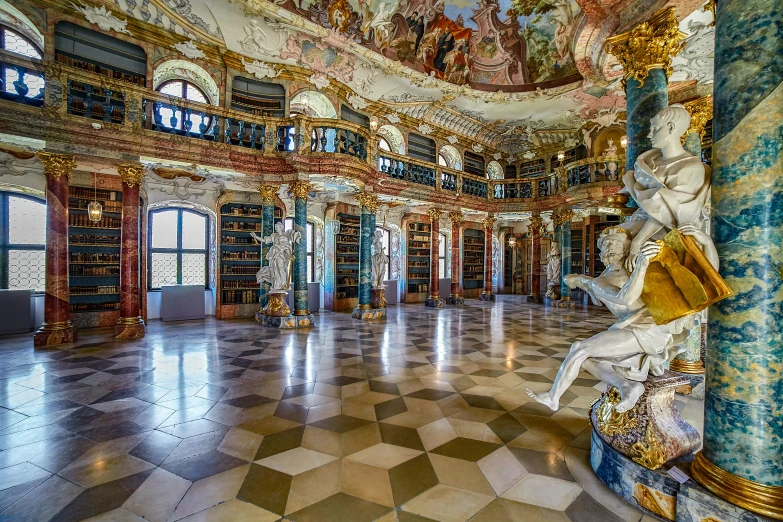 an ornate room has two large bookshelves and columns
