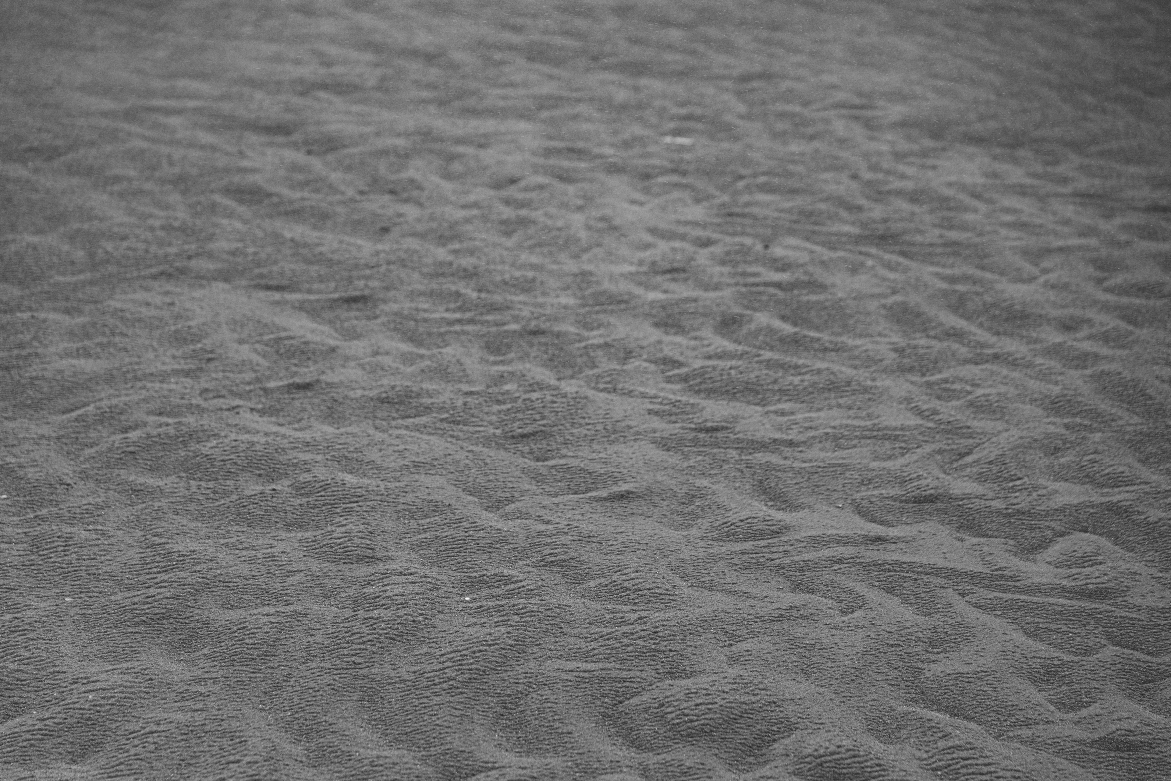 a person standing on a beach in the sand