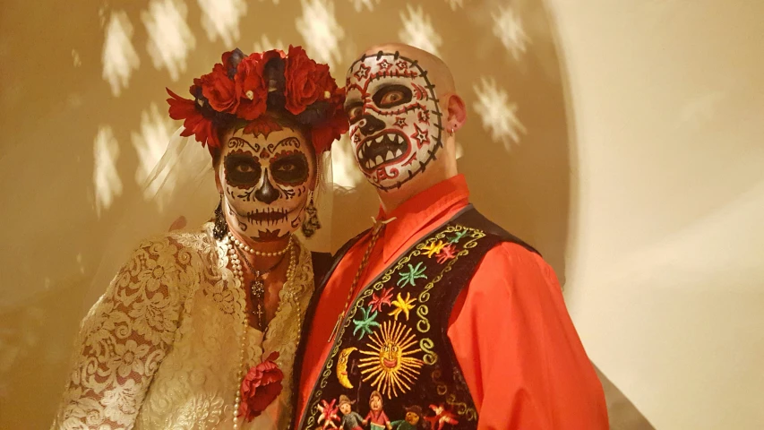two people dressed in skeleton body paint and sugar decorations