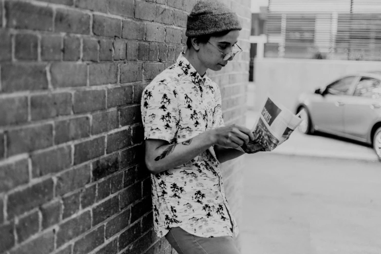 black and white pograph of a man reading from the newspaper