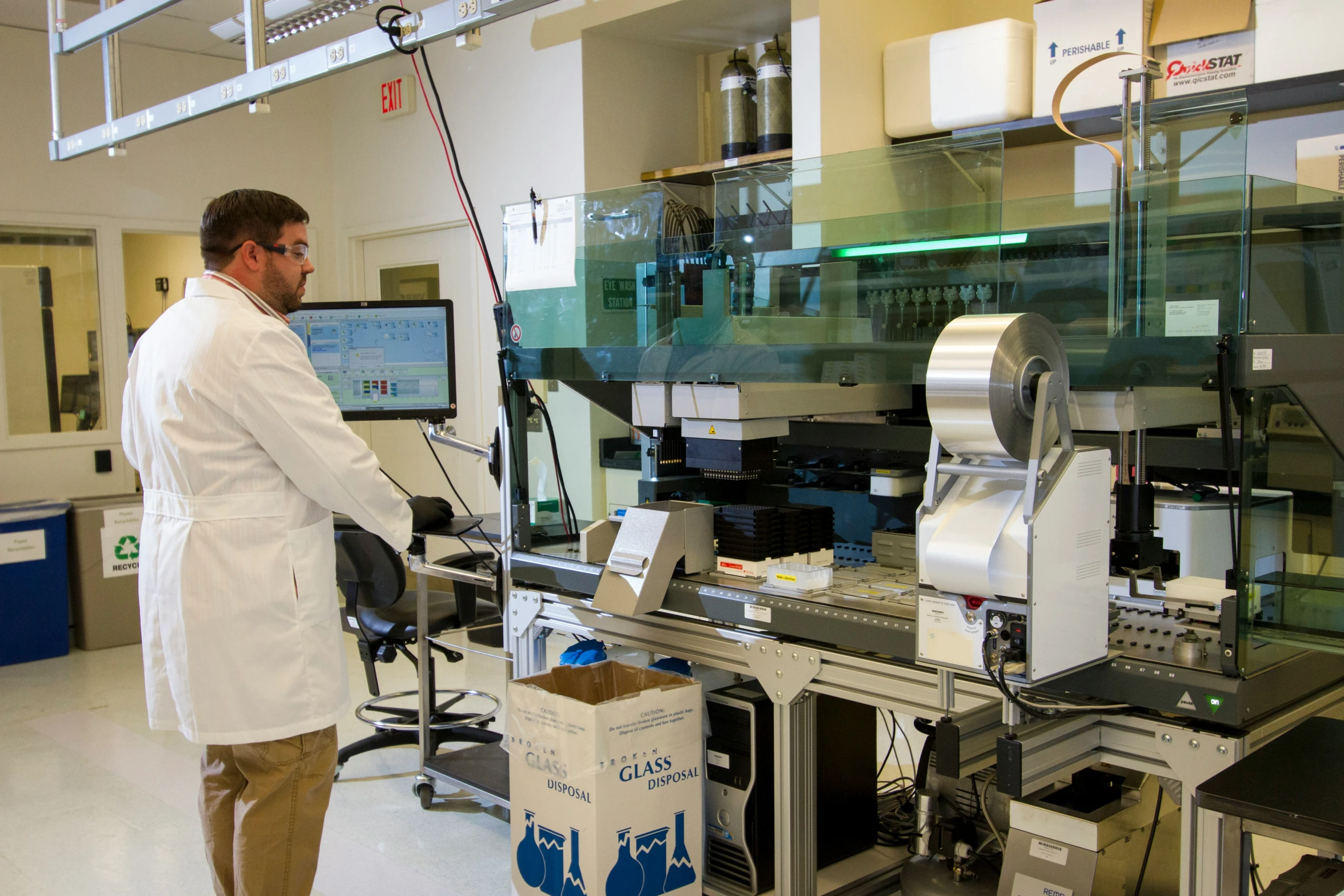 a man stands near a machine that has three pieces of paper in it