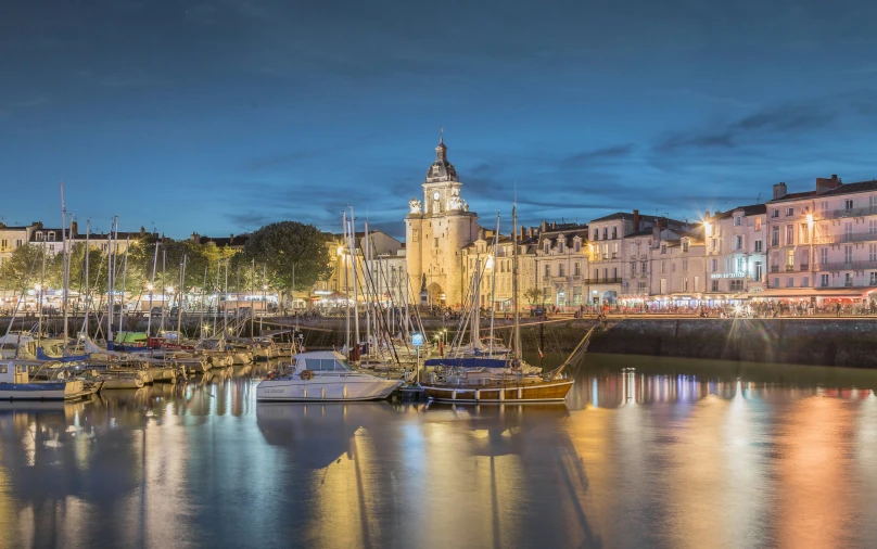 this is an image of boats in the water near a city