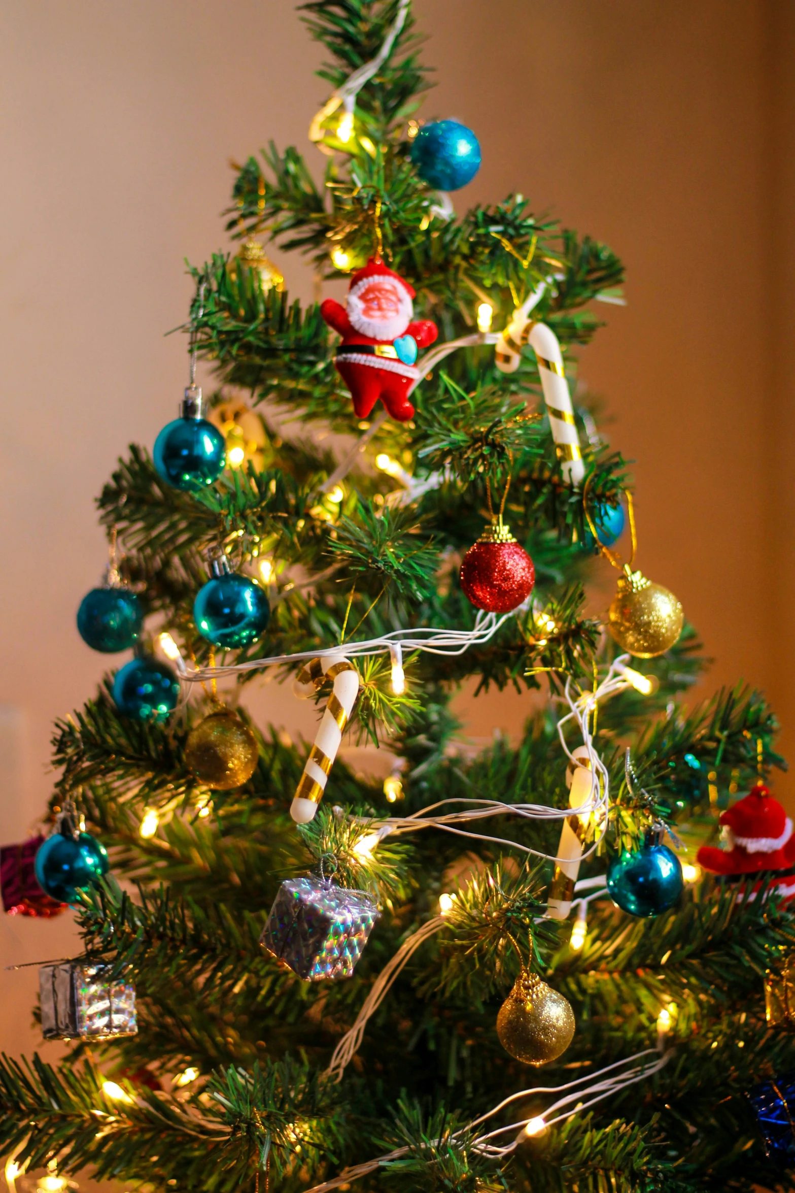 a small christmas tree with a very colorful ornament