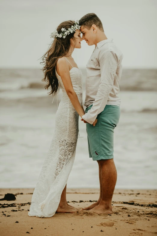 two people that are standing together in front of the water