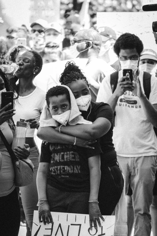 group of people with masks and one holding onto another