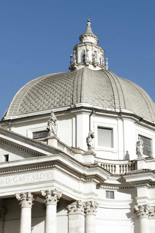 the dome of the building features statues on it