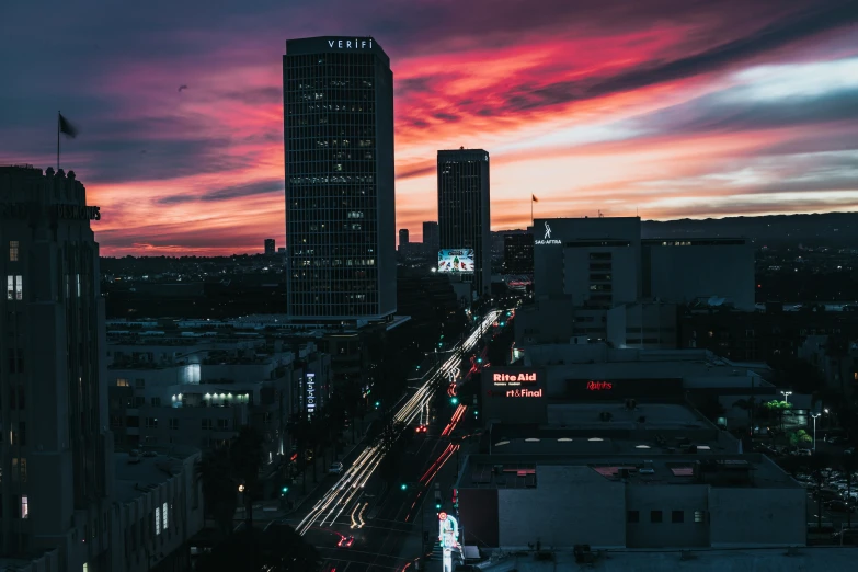 a city at night with cars driving down it