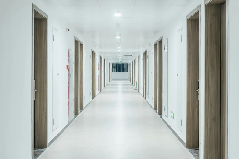 an empty corridor with multiple doors next to each other