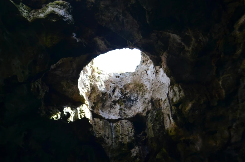 a view into a cave with the light streaming through