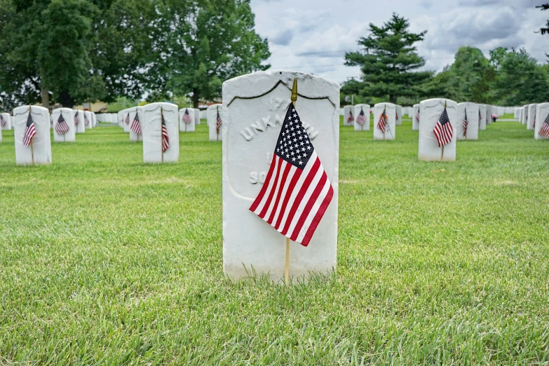 a gravestone with american flags in it