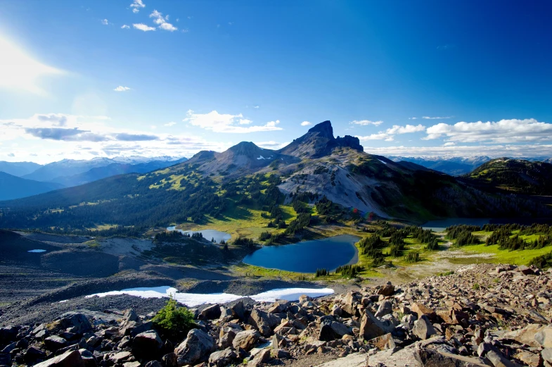 a view from the top of a hill looking over a mountain range