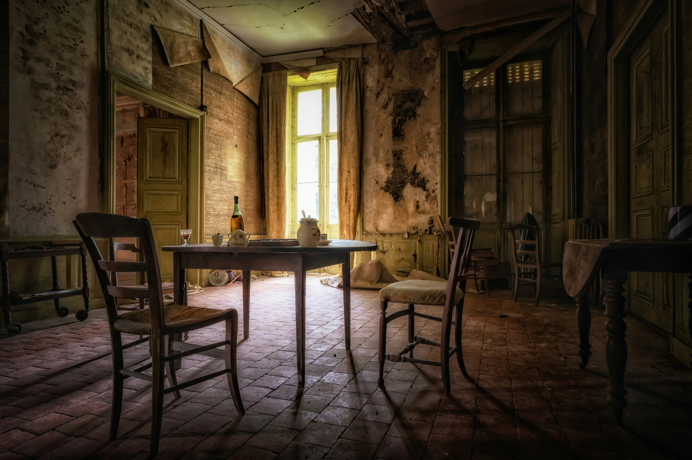 an old kitchen has a large table and two chairs