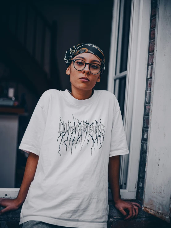 a person wearing glasses standing on a porch