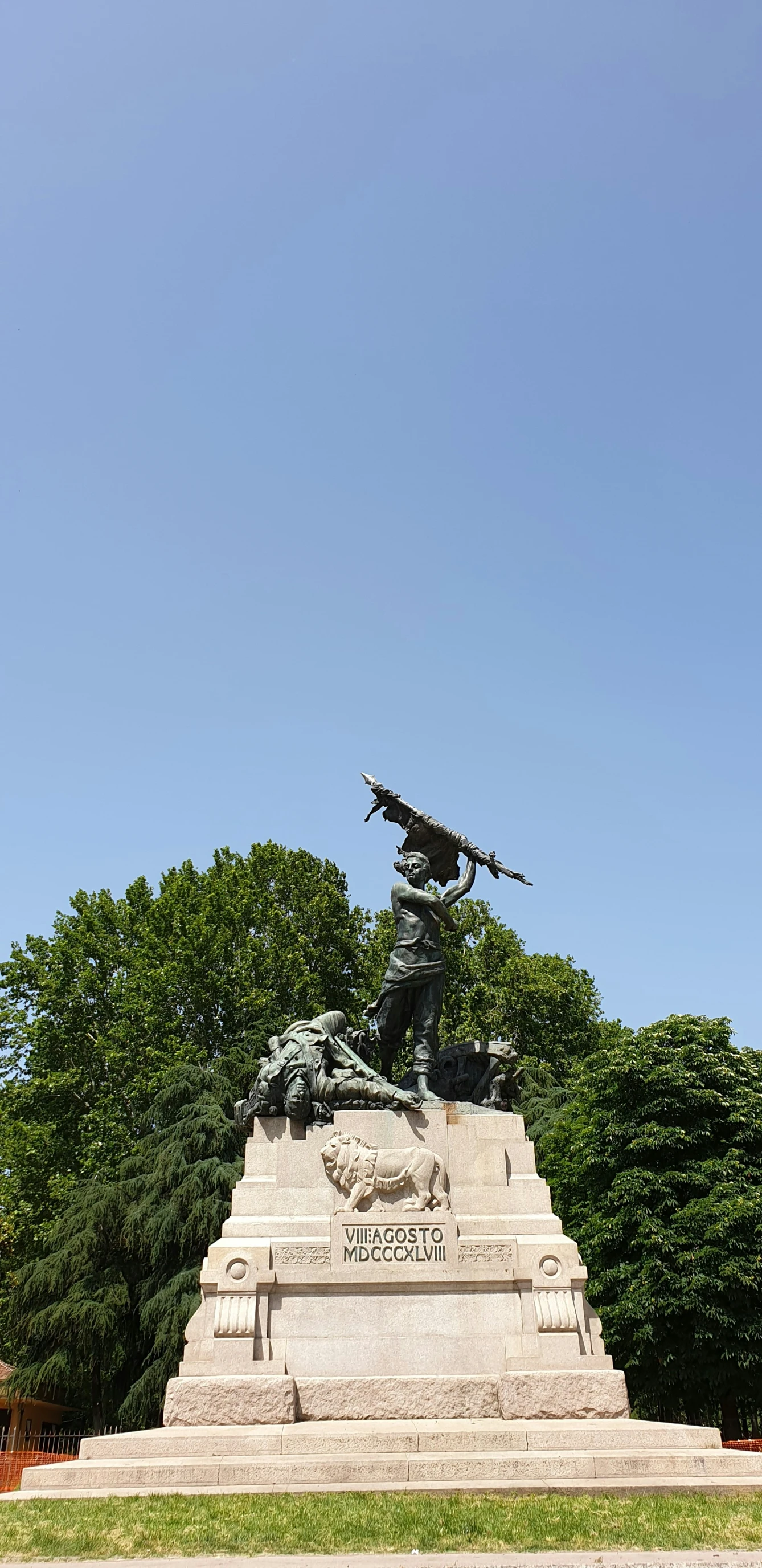 a statue in a park with some trees