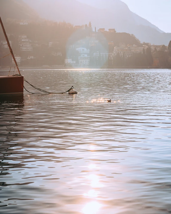 a view of the water from the shore, with a boat on it