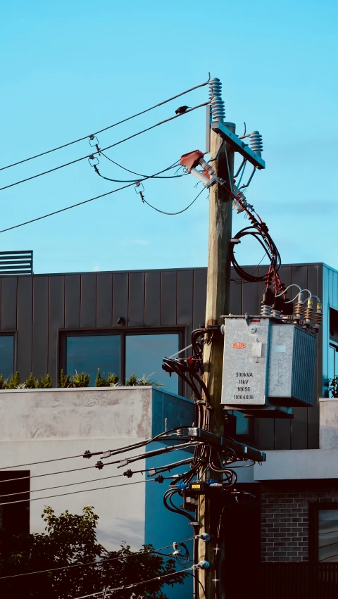 an old telephone pole with a lot of wires above