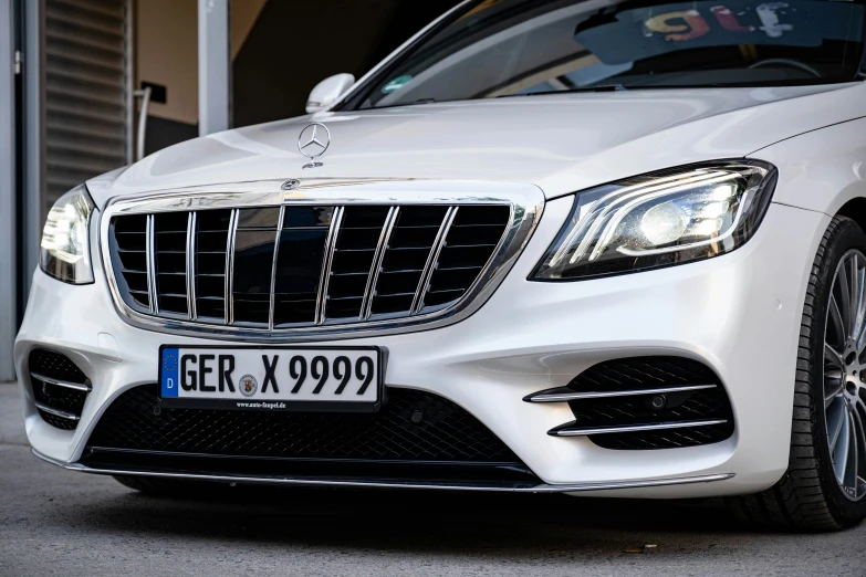 the front end of a white mercedes s - class