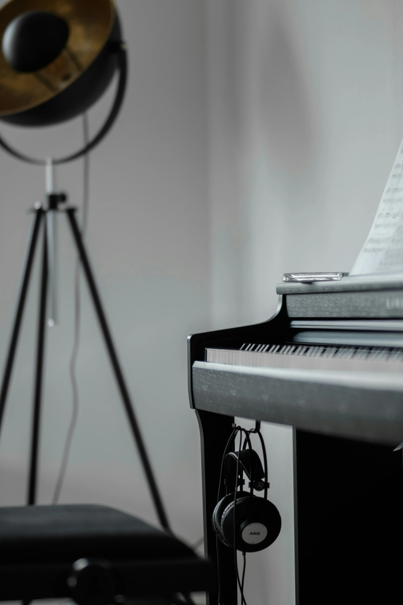 a close - up of the piano with headphones, microphone and tripod