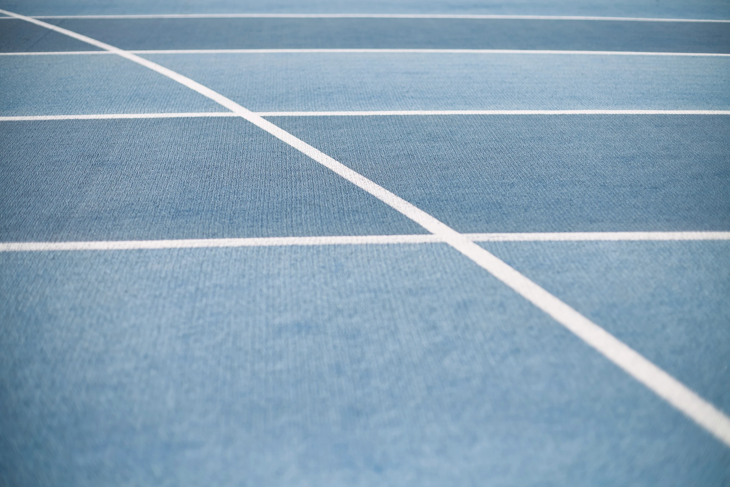 a tennis court with lines and a blue surface