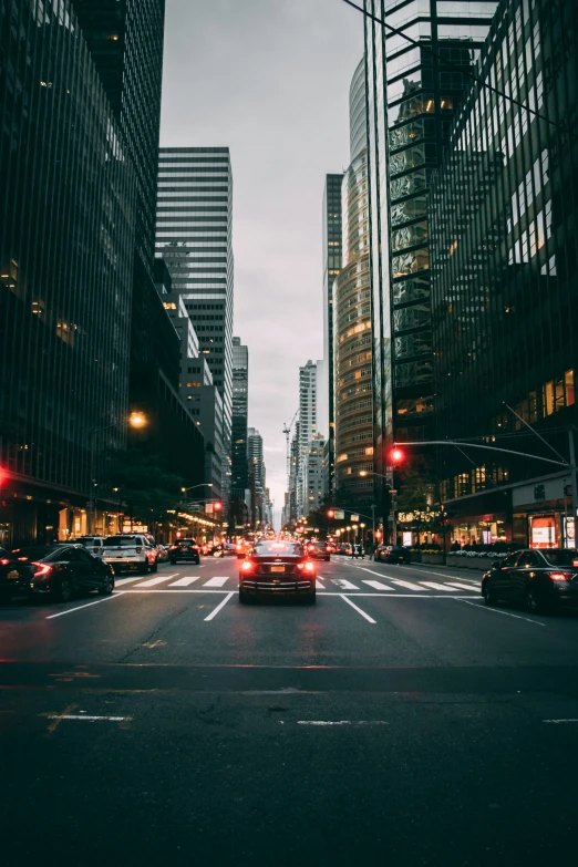 an empty city street filled with lots of cars