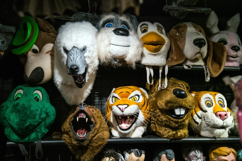 stuffed animal masks are on display for sale at a store