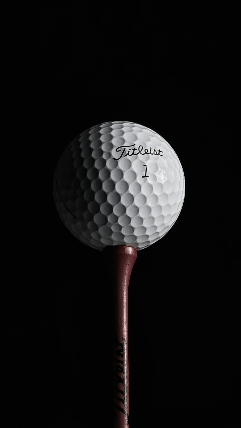 a golf ball sitting on top of a wooden tee