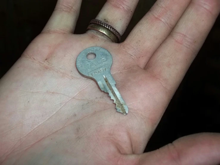 this is a tiny key to the side of someone's hand
