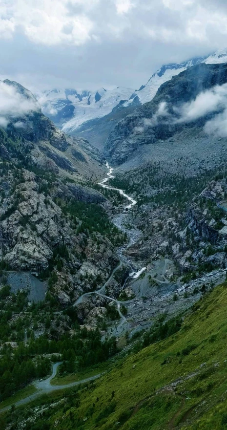 an alpine area has mountains with snow on top