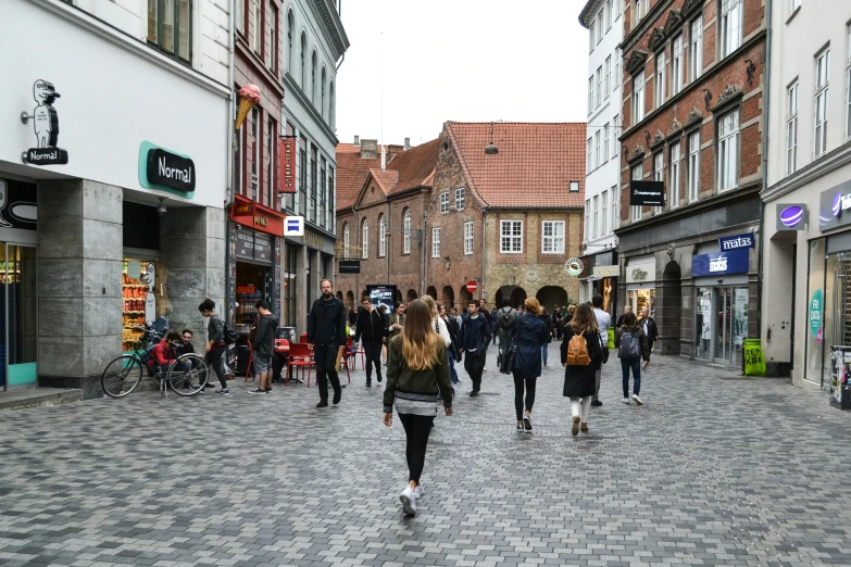 a busy city street with people walking down the center