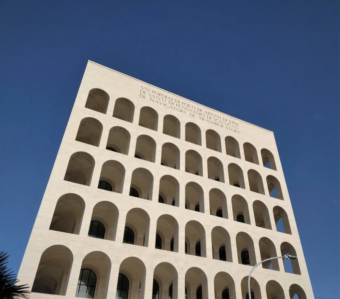 the facade of an arched concrete building