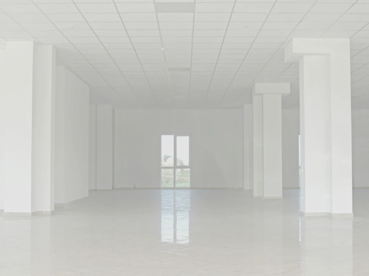a white room with columns and windows and light in it