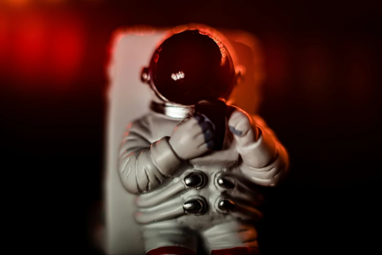 a 3d astronaut in white holding a red object