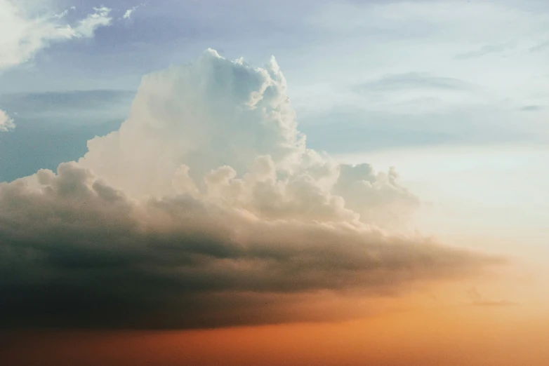 a large cloud formation over a sunset sky