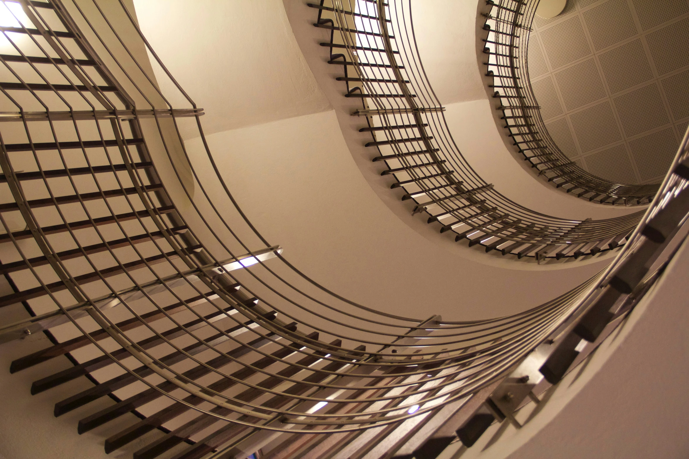 a large spiral staircase with mirrors reflecting it's design