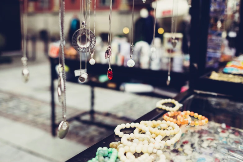 several different colored beads hanging from a rail